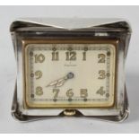 An unusual Art Deco Cartier sterling novelty desk clock. The rectangular Arabic dial with gilt