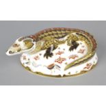 A Royal Crown Derby porcelain paperweight modelled as a crocodile, with red printed marks and gold