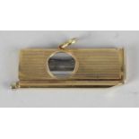 A 9ct gold cigar cutter and piercer, the body of rectangular form with engine turned decoration,