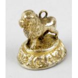 A 19th century gilt metal and carnelian armorial fob seal. Modelled as a standing lion, the oval