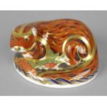 A Royal Crown Derby porcelain paperweight modelled as an otter, with gold printed marks and gold