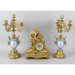 A late 19th century French porcelain-mounted mantel clock with matched garniture. The clock having a