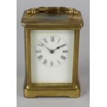 An early 20th century brass cased carriage clock, the white enamelled dial with black Roman numerals