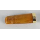 An amber cheroot holder (a/f), with 18ct gold plated mount marked H.H, in fitted case, 2 (5cm) long.