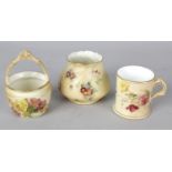 A group of Royal Worcester blush ivory porcelain items. Comprising: a miniature basket, two circular