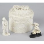 A carved ivory pot and cover, the body of oval form carved with jungle scene featuring gazelles