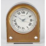 A Cartier enamelled alarm clock. The 1.75-inch Roman dial marked CARTIER, the arched brushed metal