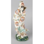 A Japanese figurine modelled as the Goddess of mercy Guanyin, in white flowing robe decorated with