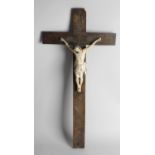 A carved wooden and painted gesso 'Corpus Christi' upon a carved fruitwood cross detailed with