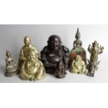 A group of assorted Eastern figures, to include four bronze examples, a Buddha, seated in meditation