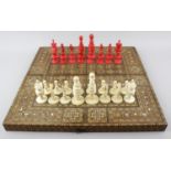 A 19th century English ivory 'Barleycorn' pattern chess set. Red-stained and natural, the rooks of