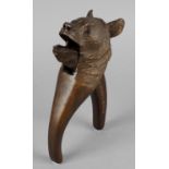 A Swiss 'Black Forest' style carved wooden novelty nut cracker, modelled as the head of a bear