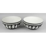 Two Wedgwood black jasperware bowls, the bodies of circular form decorated with applied white relief