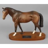 A Beswick Connoisseur model Racehorse of the Year 1979 'Troy', raised upon an oval wooden plinth,