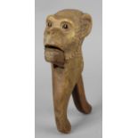 A 19th century carved wooden novelty nut cracker, modelled as the head of a monkey with inset