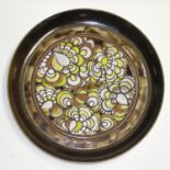 A Poole pottery 'Ionian charger by Julia F. Wills. Decorated with stylised flowers in brown and