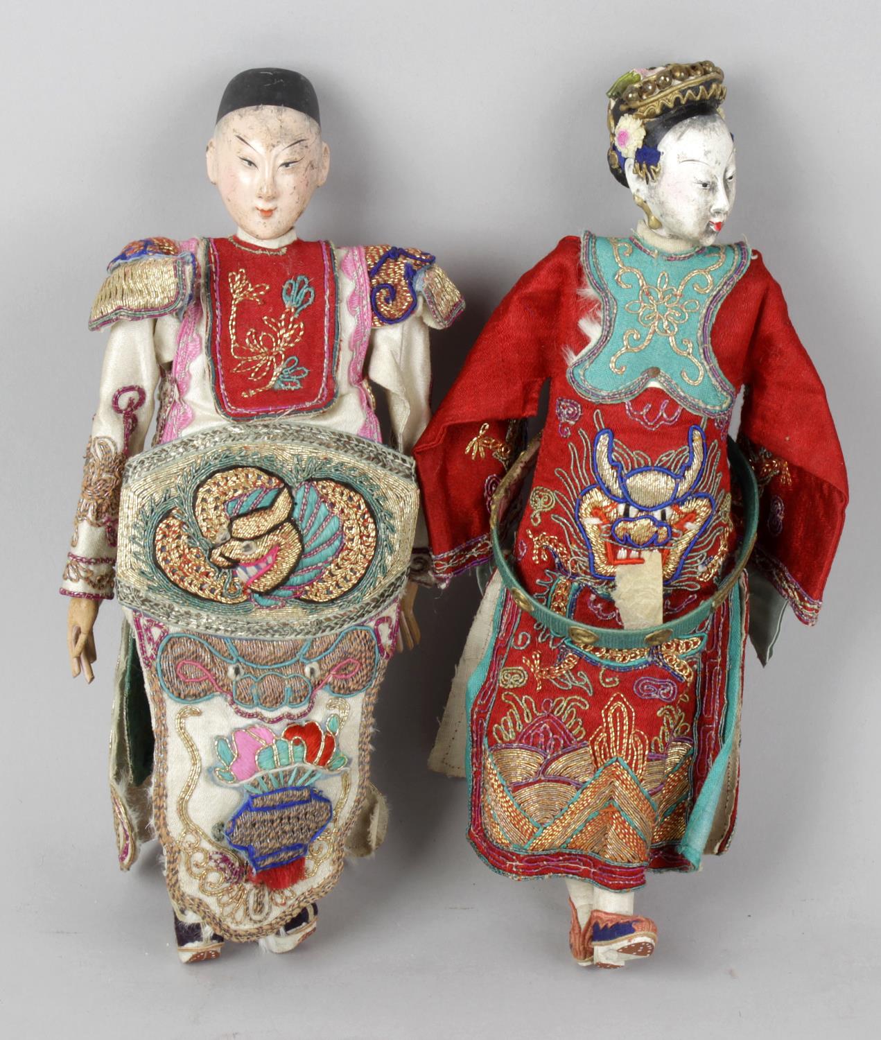 Two early 20th century Oriental dolls, each with moulded painted heads and painted moulded hands,