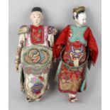 Two early 20th century Oriental dolls, each with moulded painted heads and painted moulded hands,