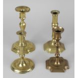 Four assorted 18th century brass candlesticks, each of typical form with socket raised upon