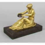 A 19th century gilt bronze figure, modelled as a seated classical female, peering into a bronze bowl