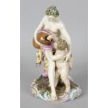 A 19th century German (Berlin) porcelain figure group. Modelled as the infant Bacchus drinking