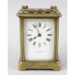 A Mappin & Webb brass-cased carriage clock. With white enamelled Roman dial named 'MAPPIN & WEBB LTD