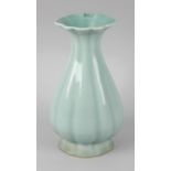 A Chinese celadon glaze vase, the body of fluted bulbous form, with waisted lobed neck, upon