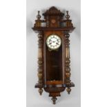 A fruitwood-cased Vienna wall clock. Hamburg American Clock Co. Ltd., the 5-inch cream Roman dial