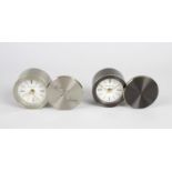 Two Tiffany & Co travel or boudoir alarm clocks. Each with circular brushed metal swivel cover