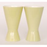 A matched pair of Poole Pottery Freeform vases of low waisted form in lime green, printed marks,