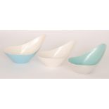 Three Poole Pottery Freeform elliptical dishes, one in pale blue,