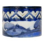 A Moorcroft cache pot decorated in the Dawn Landscape pattern with tubelined trees below a chevron