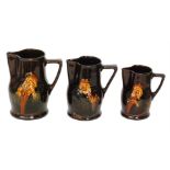 A set of three Royal Doulton Kings Ware Hogarth water jugs designed by Charles Noke each decorated