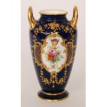 An early 20th Century Minton twin handled vase decorated with an oval hand painted floral cartouche