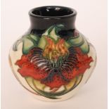 A Moorcroft Pottery vase of compressed form decorated in the Anna Lily pattern designed by Nicola