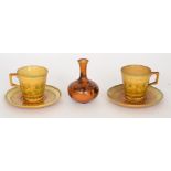 Linthorpe Pottery - Two early 20th Century shape 1899 cups and saucers decorated with incised