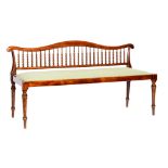 A small Edwardian beech framed two seater settee,