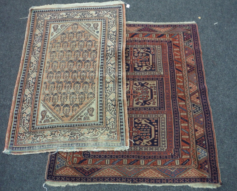 An early 20th Century Caucasian rug with three rows of guls on a rust ground,