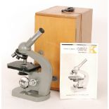 An Olympus model K Japanese microscope in oak case with instruction manual