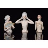 A group of three 1930s Art Deco porcelain half dolls modelled as nude females,