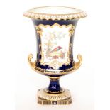 A Royal Crown Derby pedestal vase decorated with a hand painted cartouche panel with a stylised