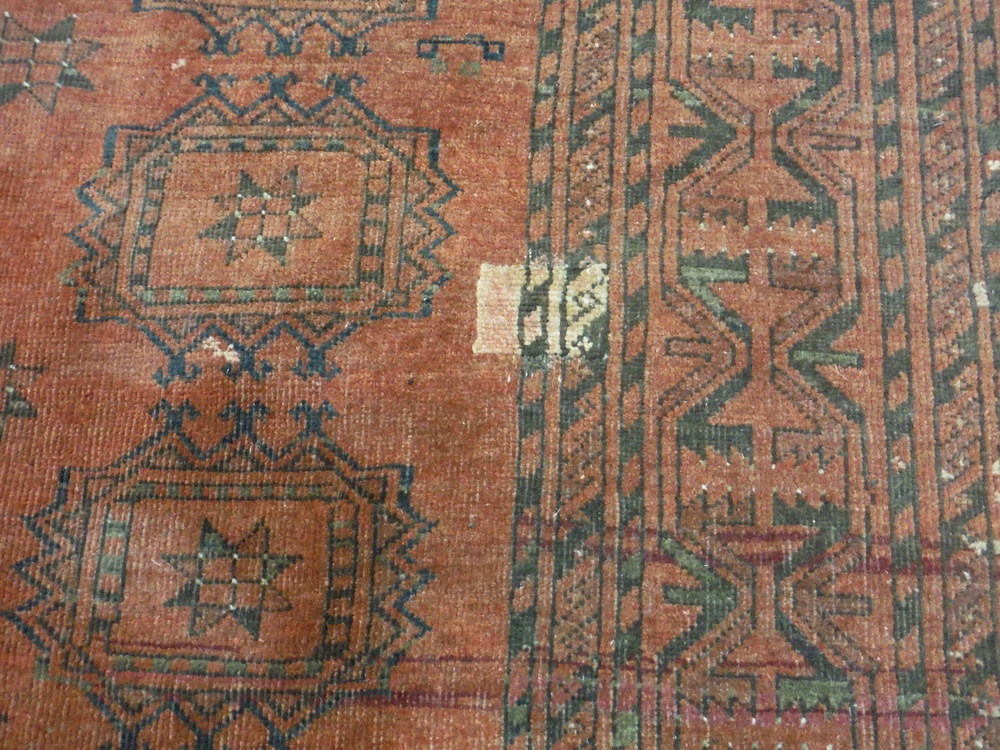 An early 20th Century Middle Eastern flat woven maroon rug, with repeat pattern, 227cm x 166cm, A/F. - Image 4 of 5