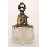 An Eastern Persian crystal perfume bottle with cut faceted sides of birds of prey mounted with a