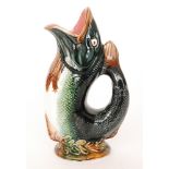 A late 19th to early 20th Century majolica gurgle fish jug with a pink glazed interior, unmarked,