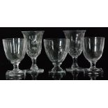 A collection of five crystal glass goblets to include a pair of footed form with circular facet