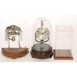 A 1940s 800 day mantle clock in glass dome on turned mahogany base together with similar part