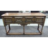 A 20th Century oak dresser base, fitted with three panel fronted frieze drawers above turned legs,