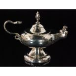 An Edwardian hallmarked silver Aladdin's lamp table lighter with snake scroll handle and flame