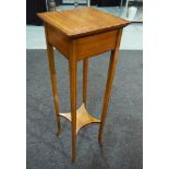 A satinwood jardiniere stand or torchere of square form, with walnut cross banded borders,