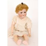 An Armand Marseille bisque head doll with open close eyes and mouth, jointed composition body,